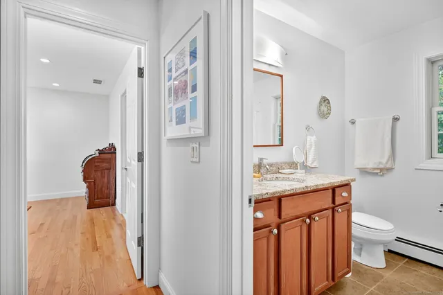 a en suite bathroom with a granite countertop sink toilet and shower