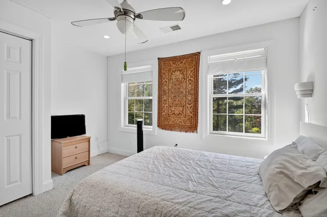 a bedroom with a bed and a tv