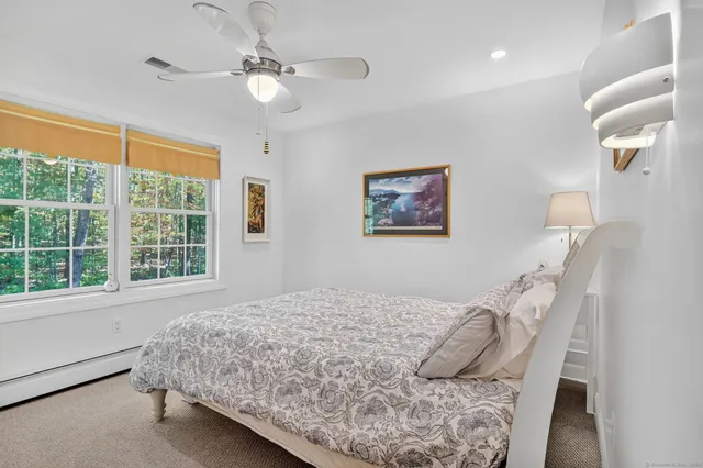 a bedroom with a large bed and a window