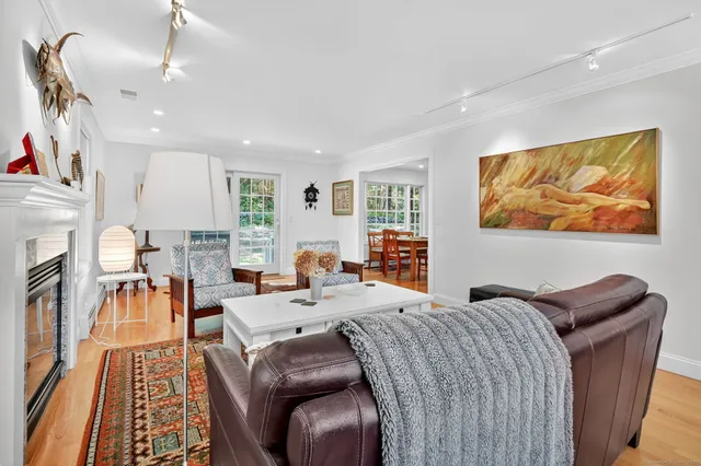 a living room with furniture a fireplace and a flat screen tv
