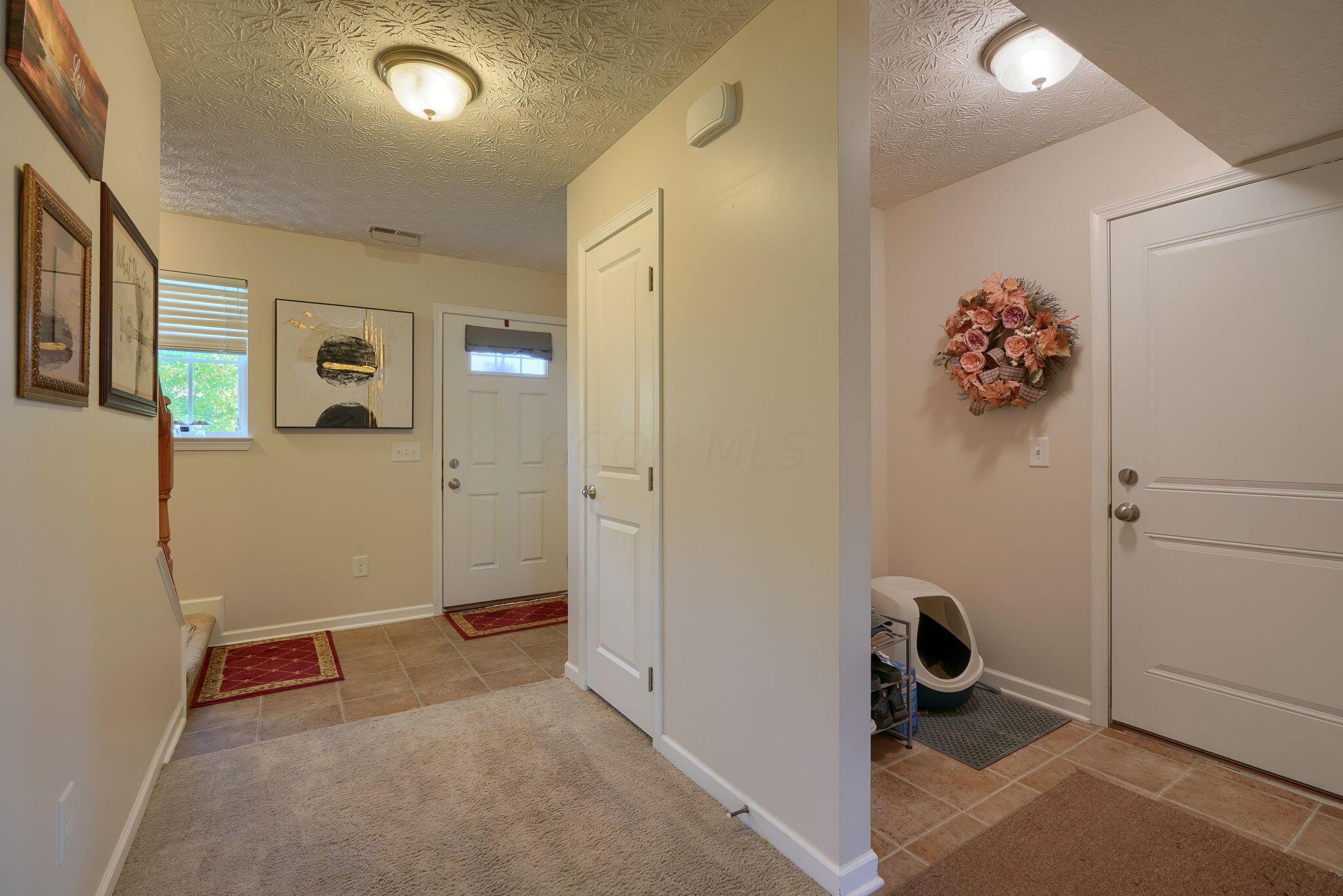 5747 Little Red Rover Street Groveport, OH 43125 - Photo 34 of 47 hallway to front door and garage area