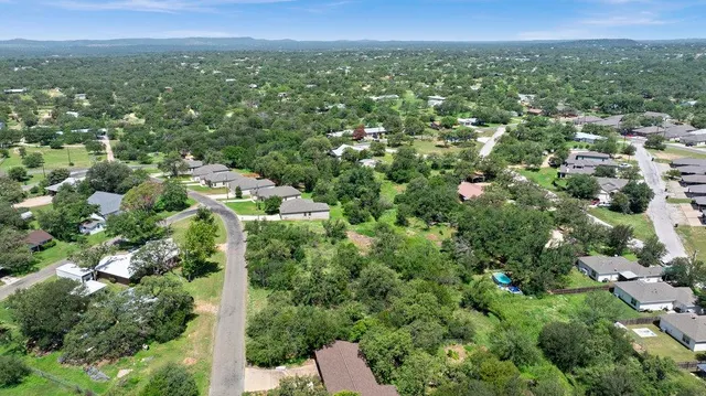 a view of a city with lush green forest