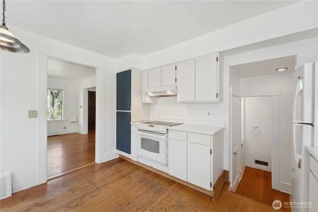 a kitchen with a stove a refrigerator and a sink
