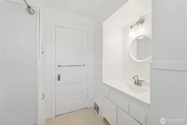 a bathroom with a sink vanity tub and shower