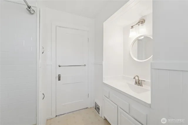 a bathroom with a sink vanity tub and shower