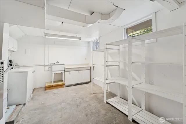 a kitchen with white cabinets and white appliances