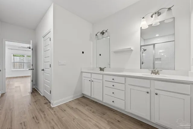 a spacious bathroom with double vanity and mirrors