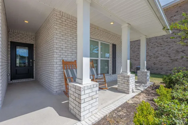 a living room with patio furniture and a large window