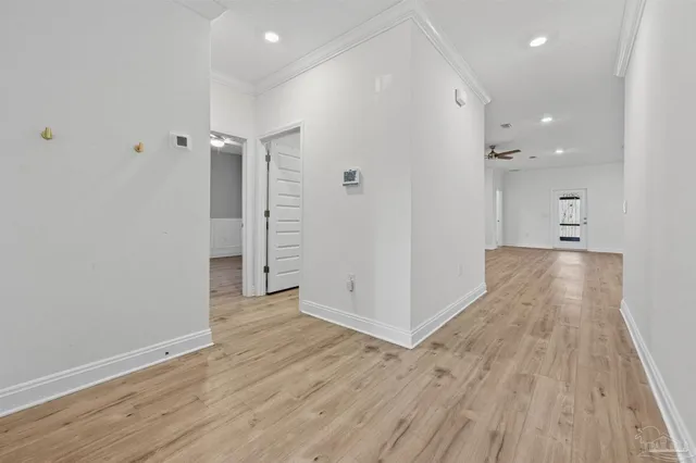 a view of a hallway with wooden floor