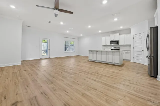 a view of kitchen with cabinets and wooden floor