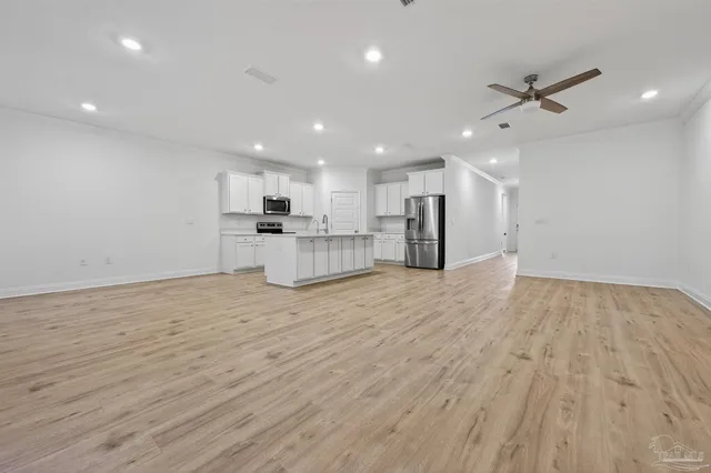 a view of a kitchen with a sink and a refrigerator