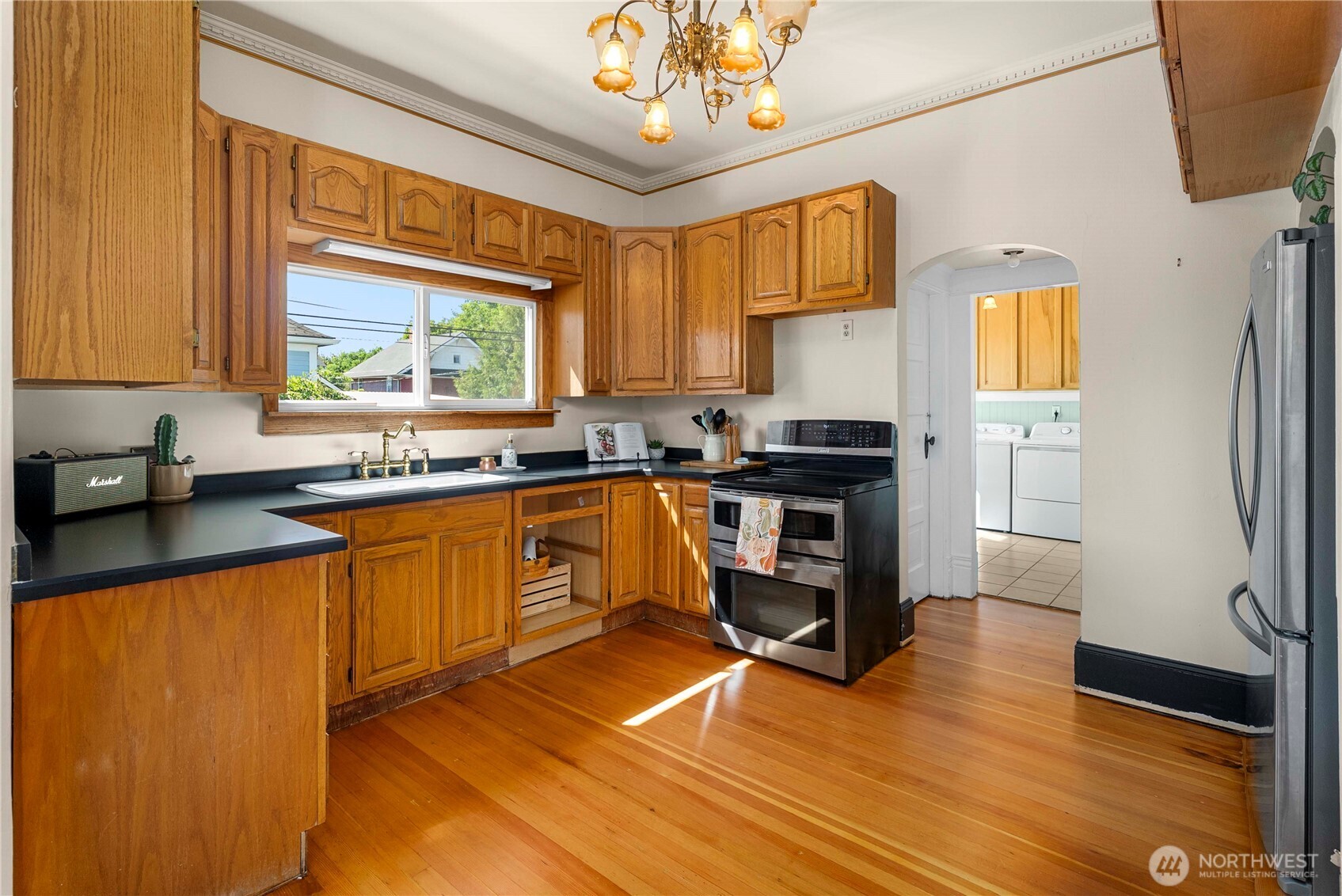 703 E Street Centralia, WA 98531 - Photo 11 of 37 a kitchen with stainless steel appliances granite countertop a refrigerator a sink dishwasher a stove and white countertops with wooden floor