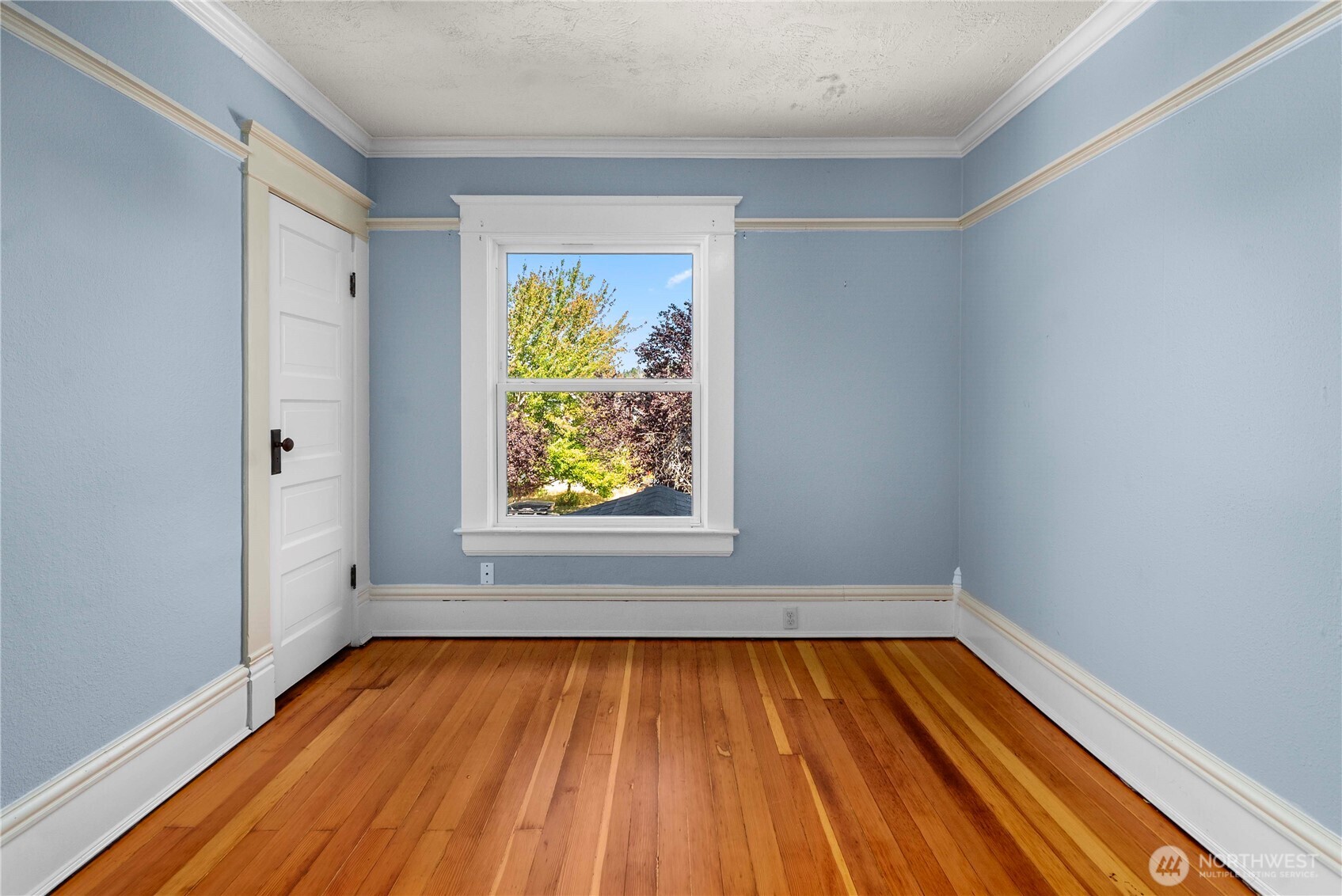703 E Street Centralia, WA 98531 - Photo 24 of 37 a view of empty room with window and wooden floor