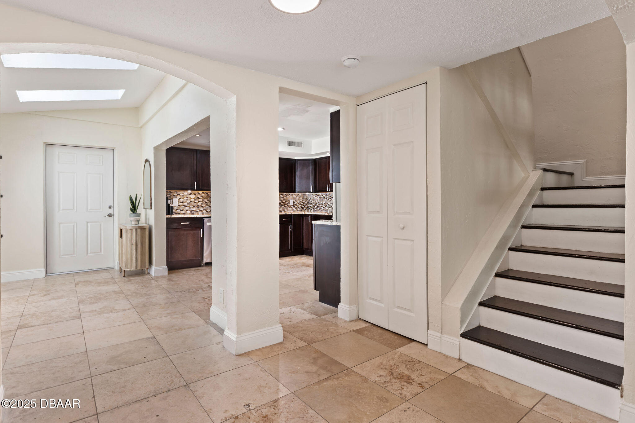 208 Pine Cone Trail Ormond Beach, FL 32174 - Photo 13 of 45 a view of a kitchen with refrigerator and an empty room