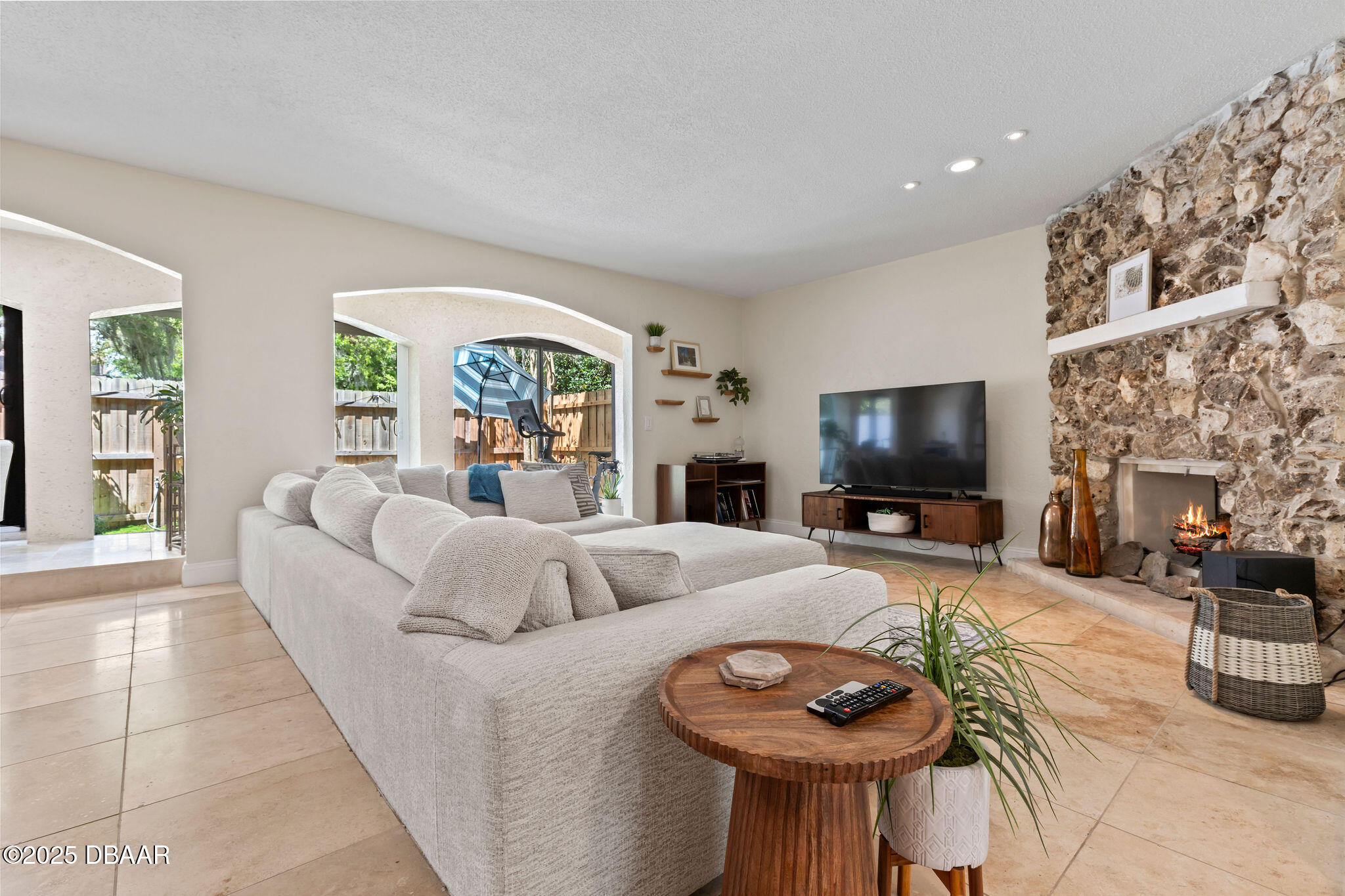 208 Pine Cone Trail Ormond Beach, FL 32174 - Photo 20 of 45 a living room with furniture a fireplace and a flat screen tv
