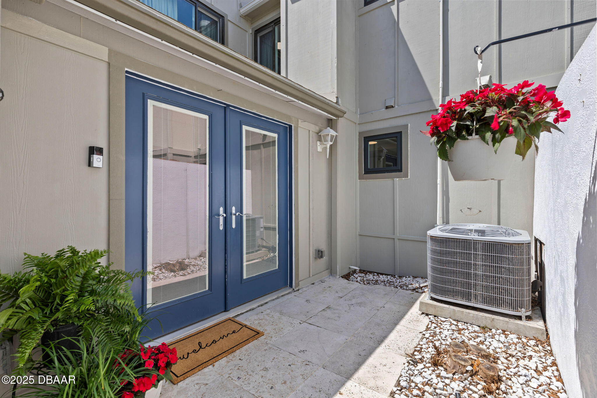 208 Pine Cone Trail Ormond Beach, FL 32174 - Photo 2 of 45 a flower garden in front of a door