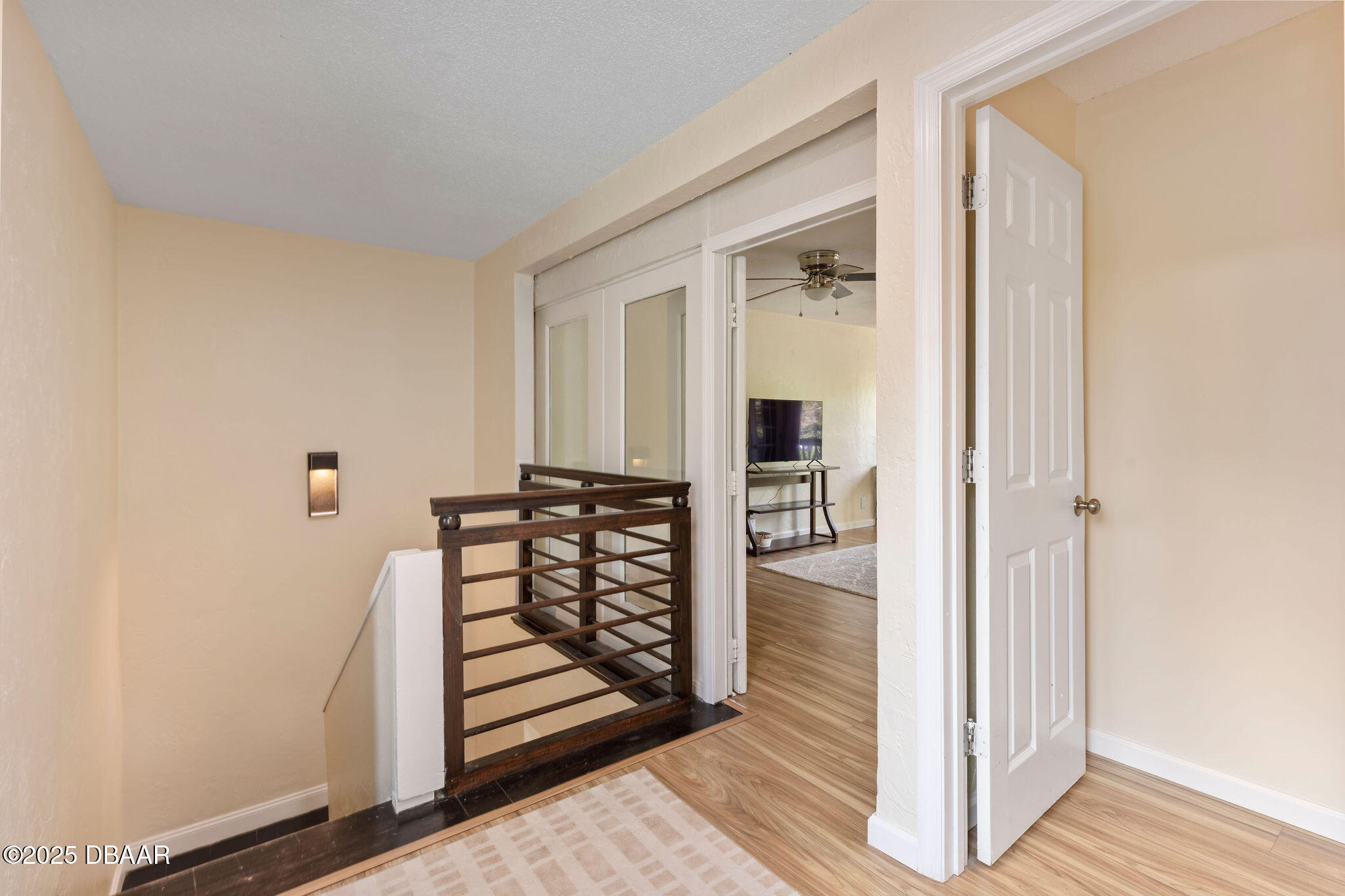 208 Pine Cone Trail Ormond Beach, FL 32174 - Photo 37 of 45 a view of a hallway with wooden floor and staircase