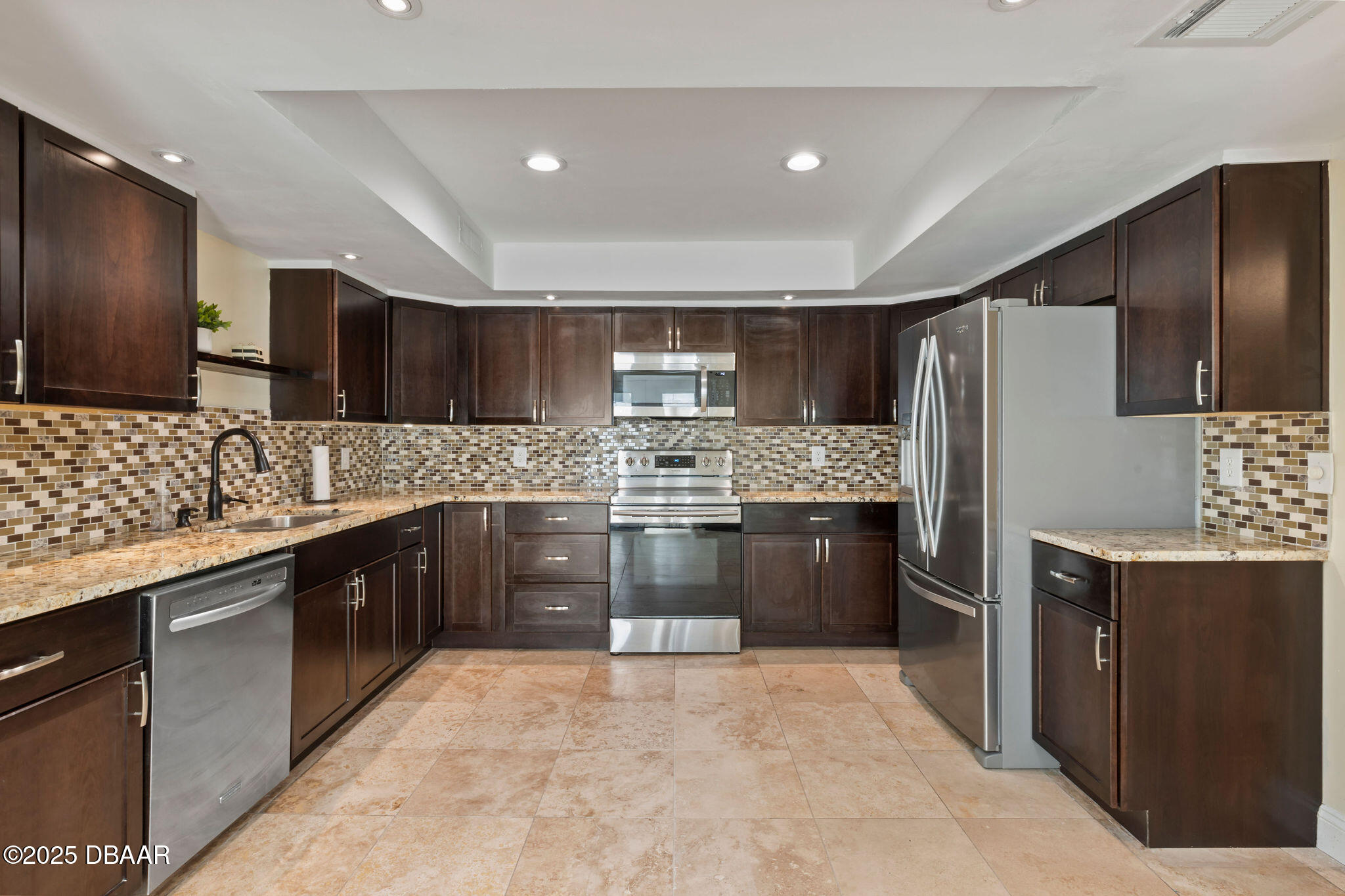 208 Pine Cone Trail Ormond Beach, FL 32174 - Photo 5 of 45 a large kitchen with cabinets and stainless steel appliances