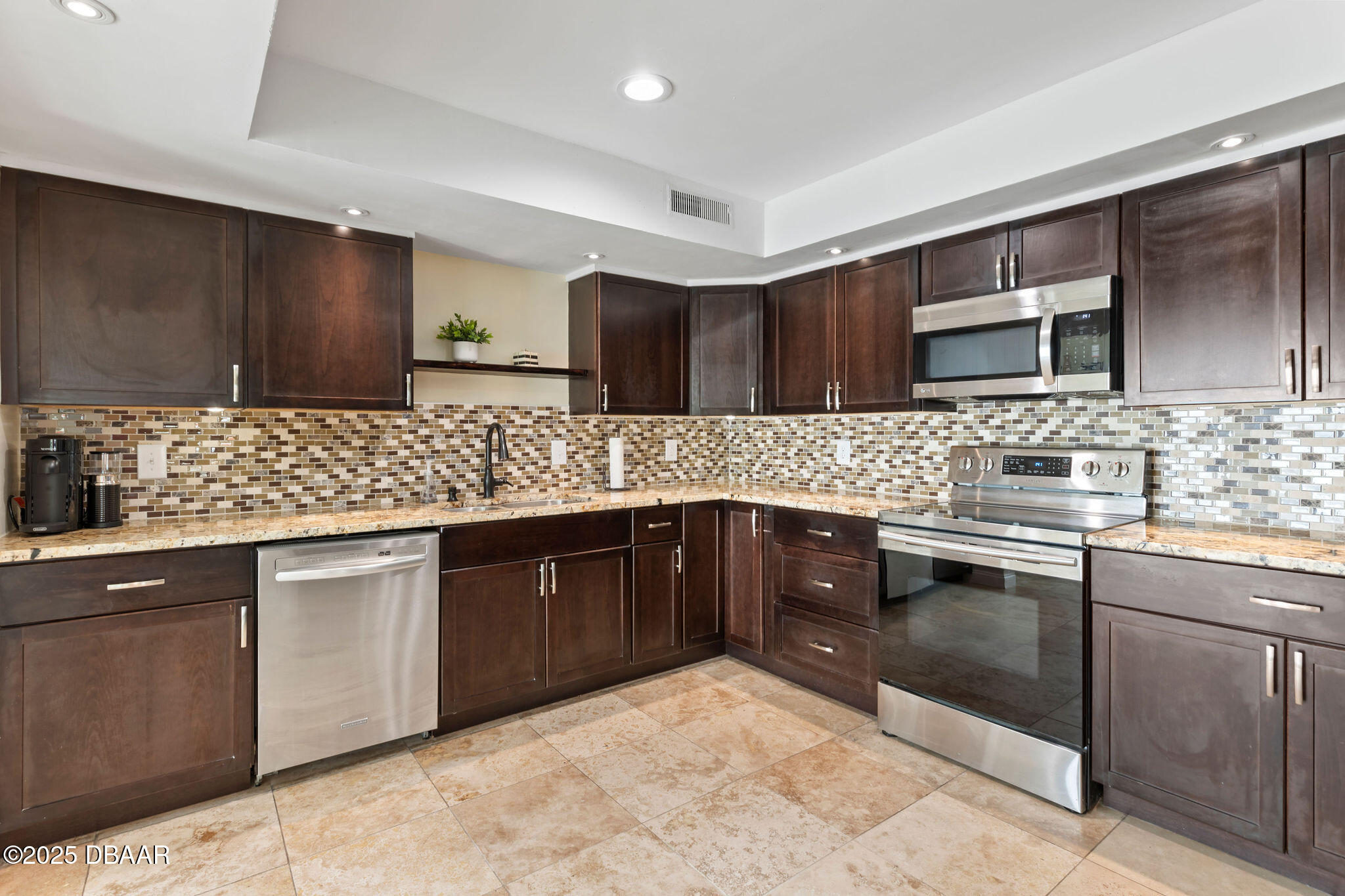 208 Pine Cone Trail Ormond Beach, FL 32174 - Photo 6 of 45 a kitchen with stainless steel appliances granite countertop a sink stove and cabinets
