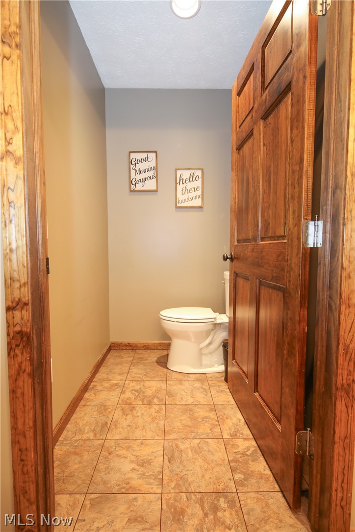 38610 Spiedel Town Road Bethesda, OH 43719 - Photo 24 of 33 Bathroom with tile patterned flooring, toilet, and a textured ceiling