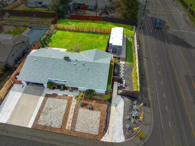 an aerial view of a house with a yard