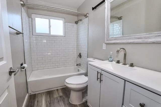 a view of a hallway with a bathroom