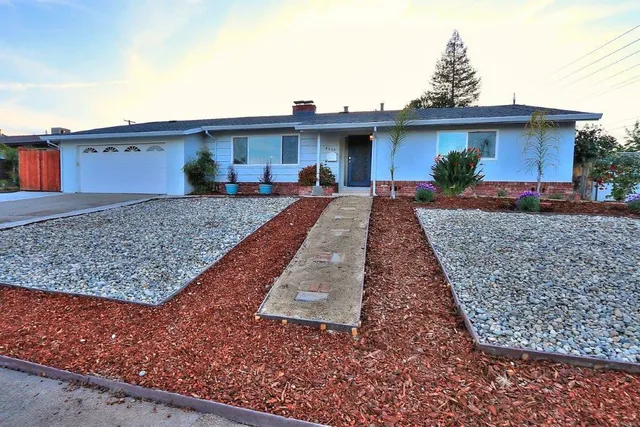 a view of a house with pool and chairs