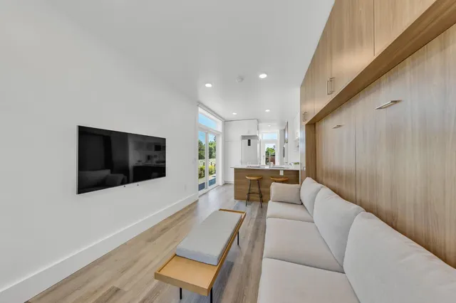 a kitchen with kitchen island a large counter top space and stainless steel appliances
