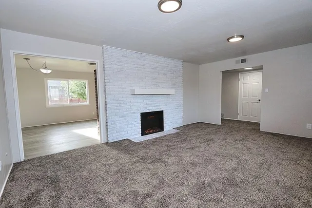 an empty room with windows and bathroom view