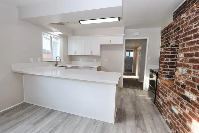 a stove top oven sitting inside of a kitchen