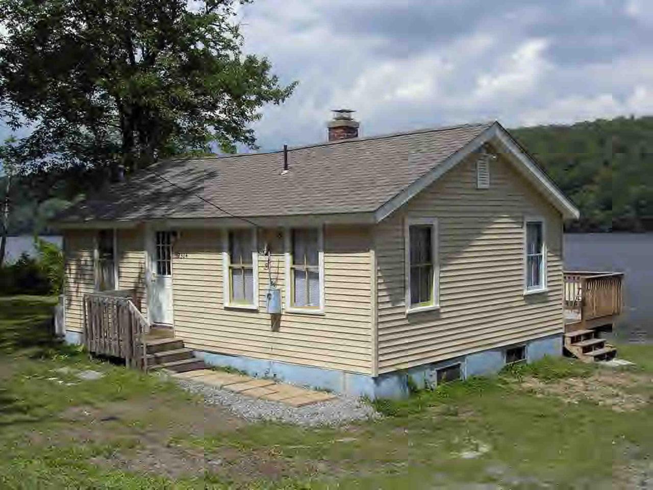 2304 North Main Road Otis, MA 01253 - Photo 3 of 8 a front view of a house with garden