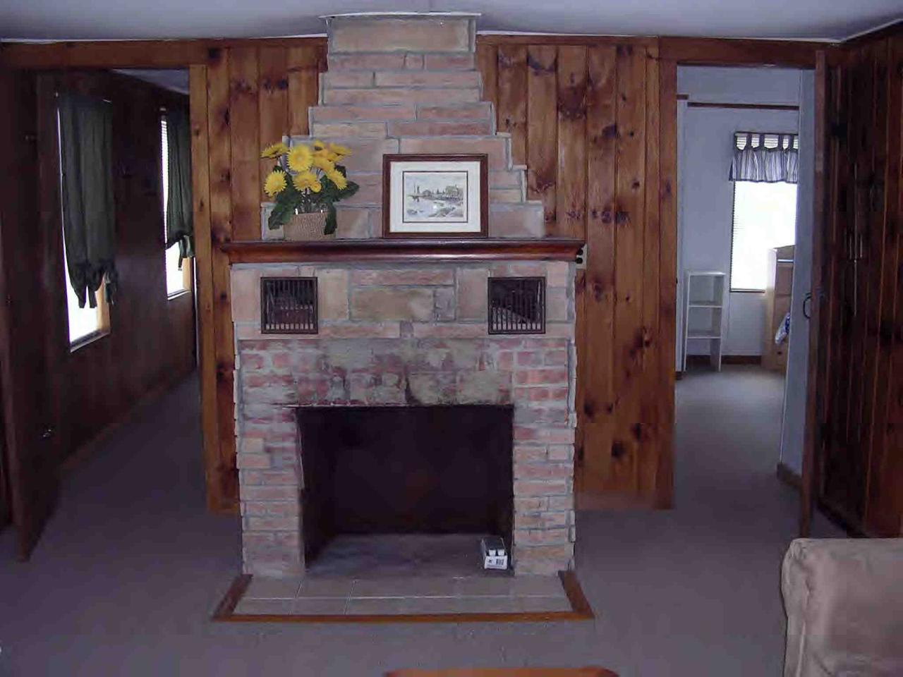 2304 North Main Road Otis, MA 01253 - Photo 4 of 8 a living room with furniture and a fireplace