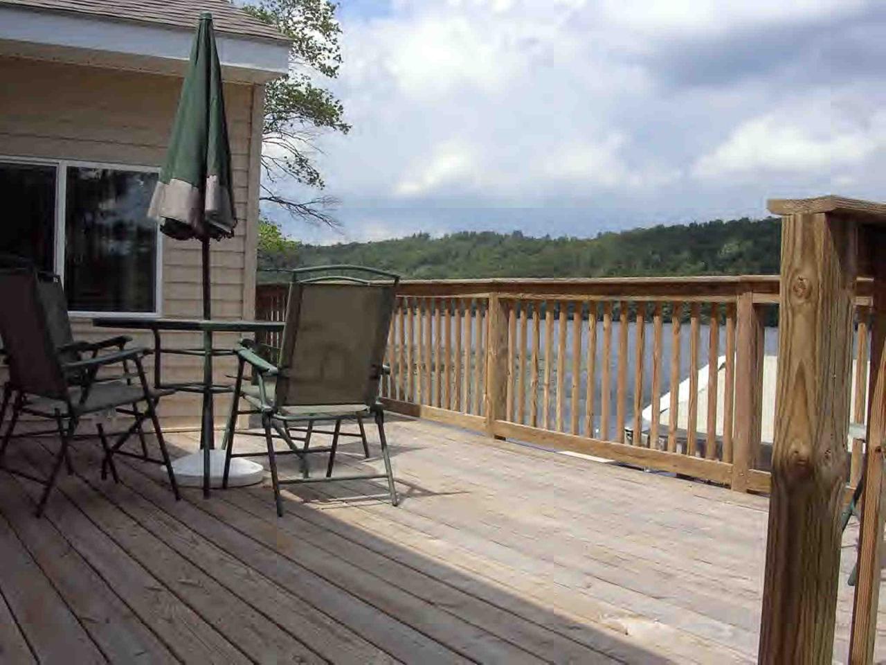 2304 North Main Road Otis, MA 01253 - Photo 6 of 8 a view of balcony with wooden floor and seating space