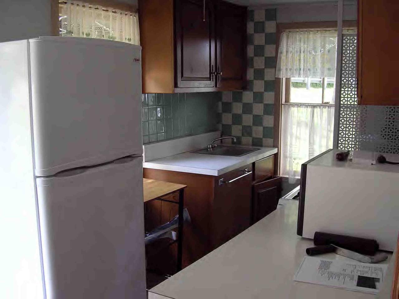 2304 North Main Road Otis, MA 01253 - Photo 7 of 8 a kitchen with a refrigerator and a stove
