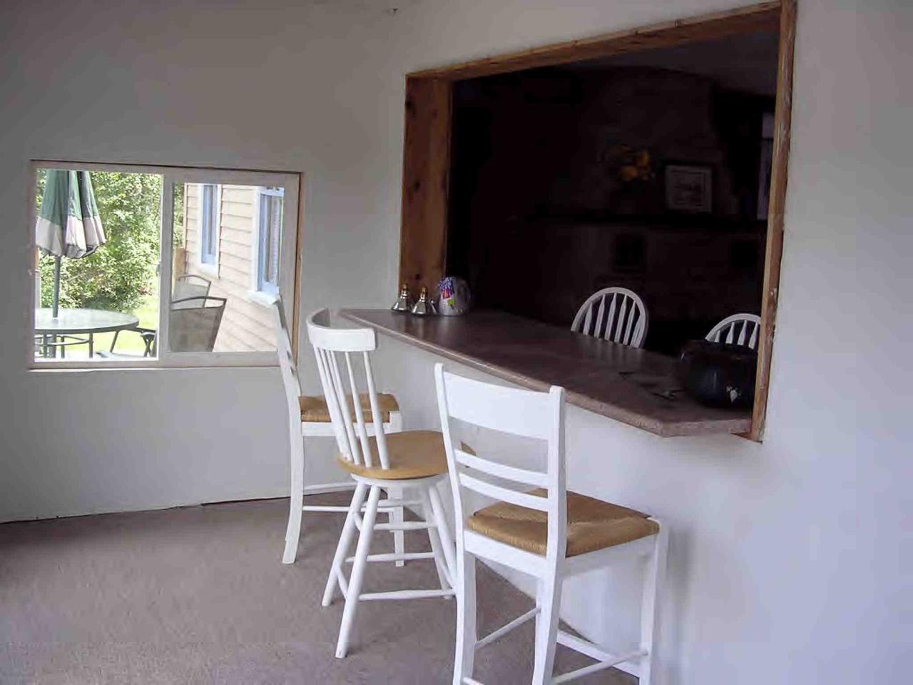 2304 North Main Road Otis, MA 01253 - Photo 8 of 8 a table and chairs in a room