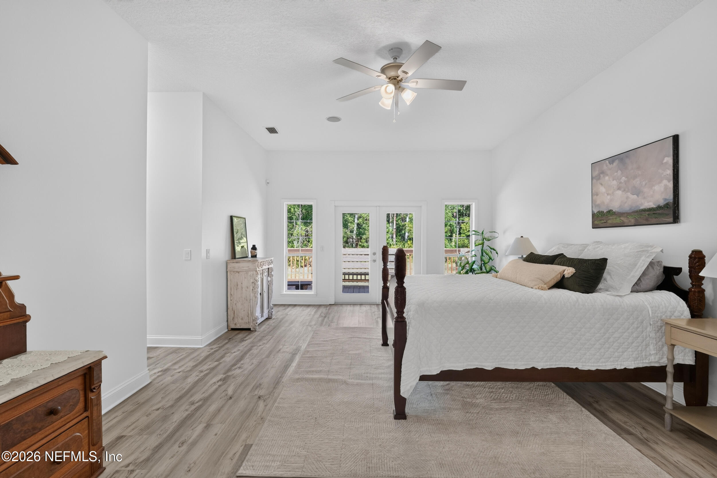 3090 Monument Bay Road St. Augustine, FL 32092 - Photo 20 of 56 a bedroom with a bed and a chandelier