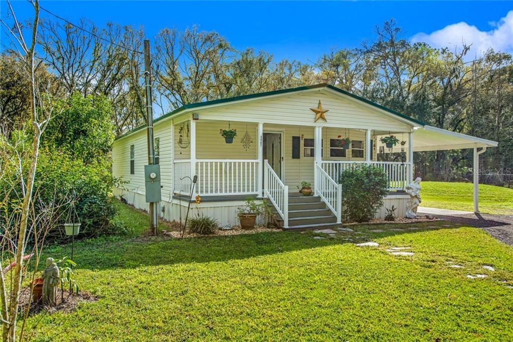 4907 Garland Branch Road Dover, FL 33527 - Photo 1 of 1 a view of a house with backyard and garden