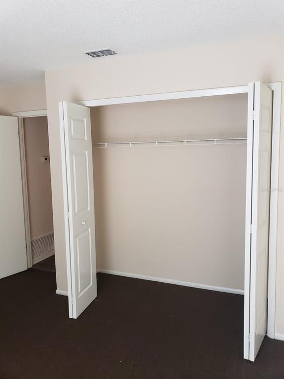 2979 Day Road, Unit C Deltona, FL 32738 - Photo 15 of 17 an empty room with wooden floor and closet