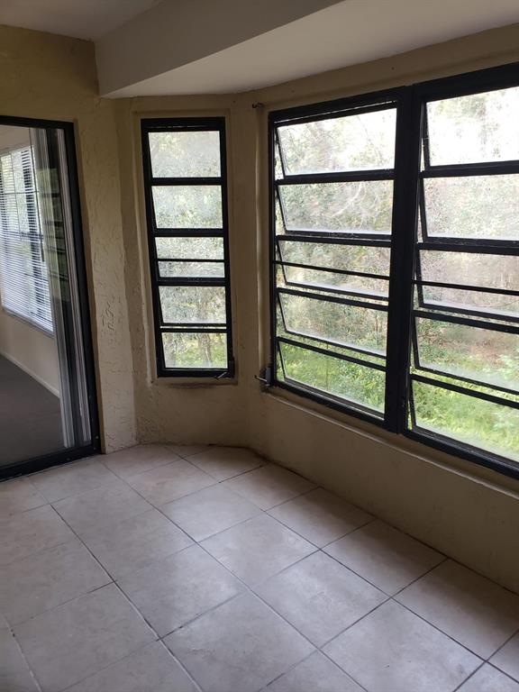 2979 Day Road, Unit C Deltona, FL 32738 - Photo 17 of 17 a view of an empty room with a fireplace and a large window