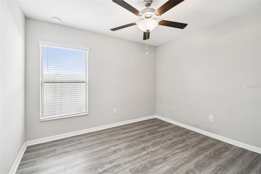 1735 Ripple Jade Place Ruskin, FL 33570 - Photo 28 of 68 an empty room with a window and a fan