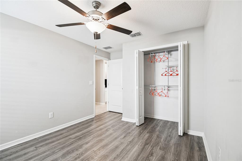 1735 Ripple Jade Place Ruskin, FL 33570 - Photo 31 of 68 an empty room with wooden floor and ceiling fan