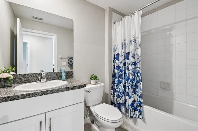 a view of a room with wooden floor and windows