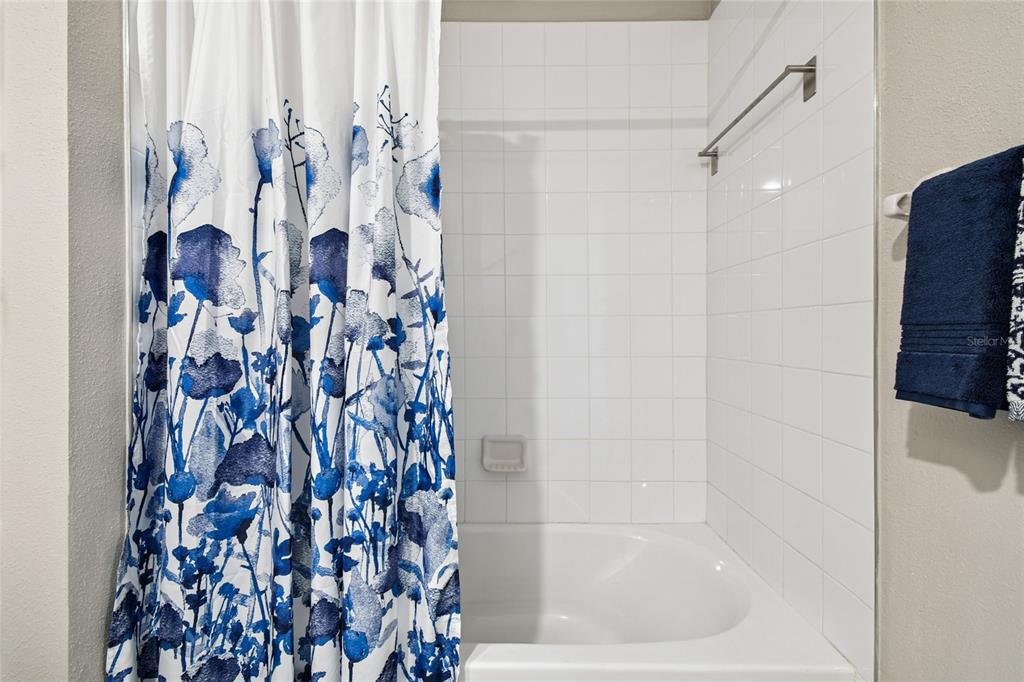 1735 Ripple Jade Place Ruskin, FL 33570 - Photo 35 of 68 a bathroom with a shower curtain and a bathtub