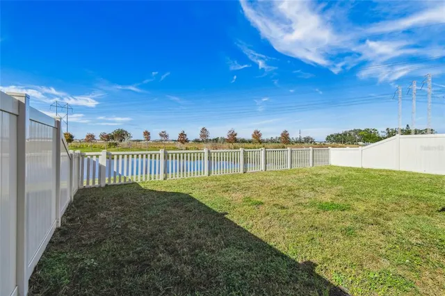 a view of a lake with houses in the back