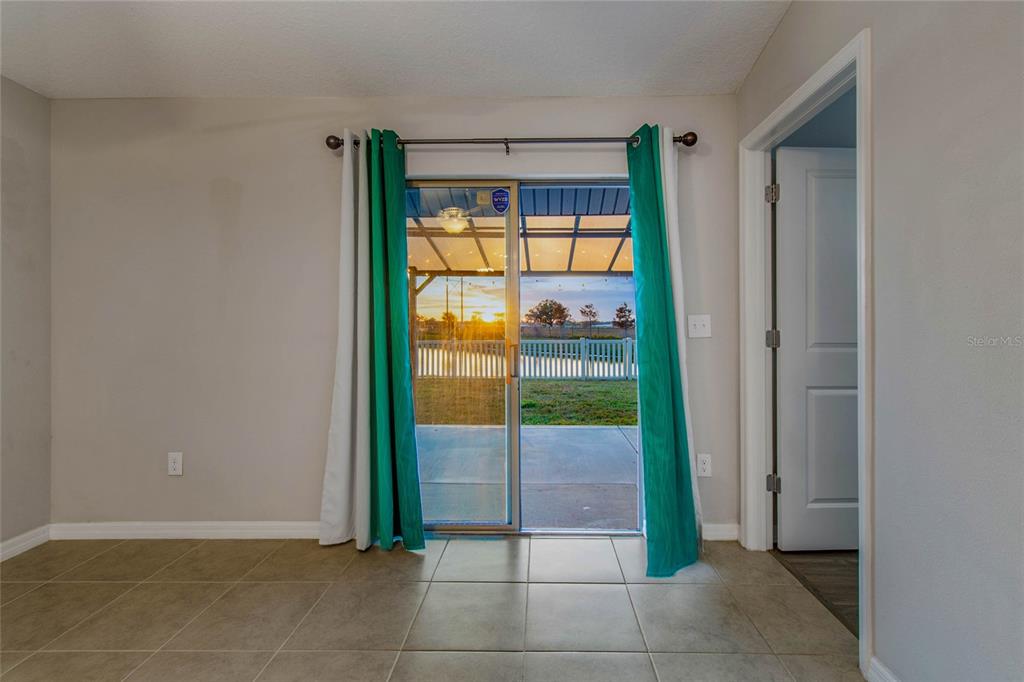 1735 Ripple Jade Place Ruskin, FL 33570 - Photo 52 of 68 an empty room with floor to ceiling window and an entryway