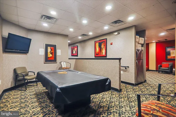 a workspace with furniture and a flat screen tv