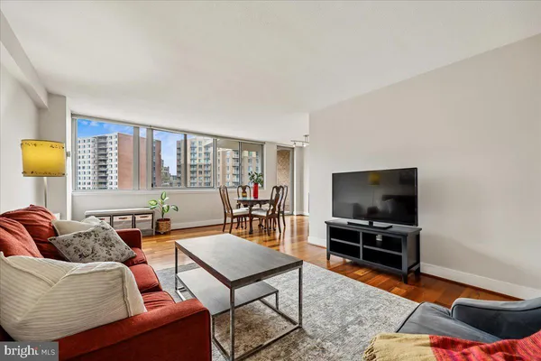 a living room with furniture a flat screen tv and a window