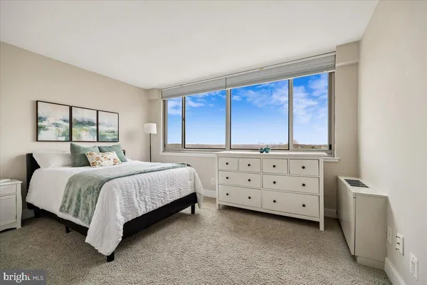 a bedroom with a bed and a dresser