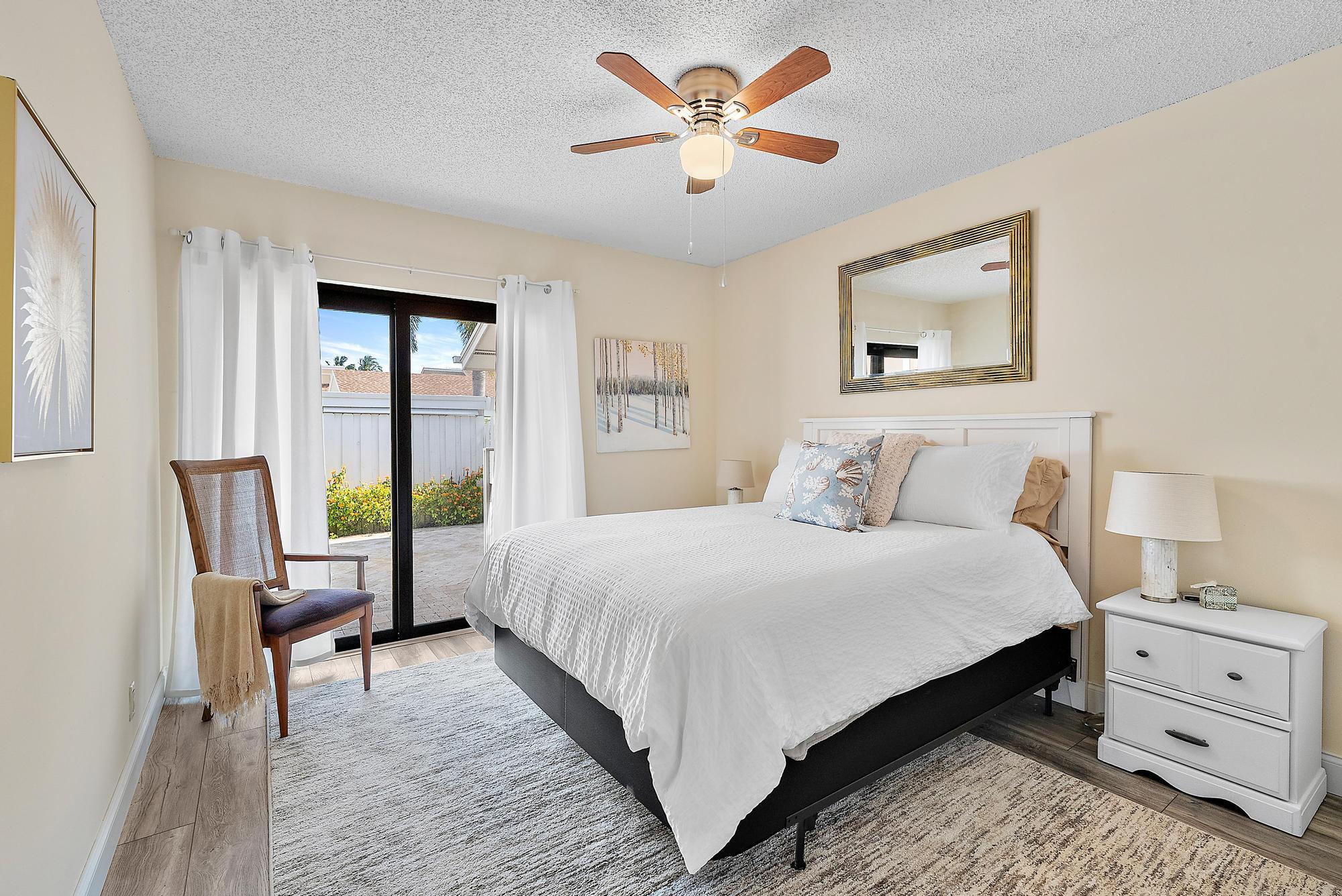 3733 Cape Pointe Circle Jupiter, FL 33477 - Photo 17 of 38 a bedroom with a bed and a painting on the wall