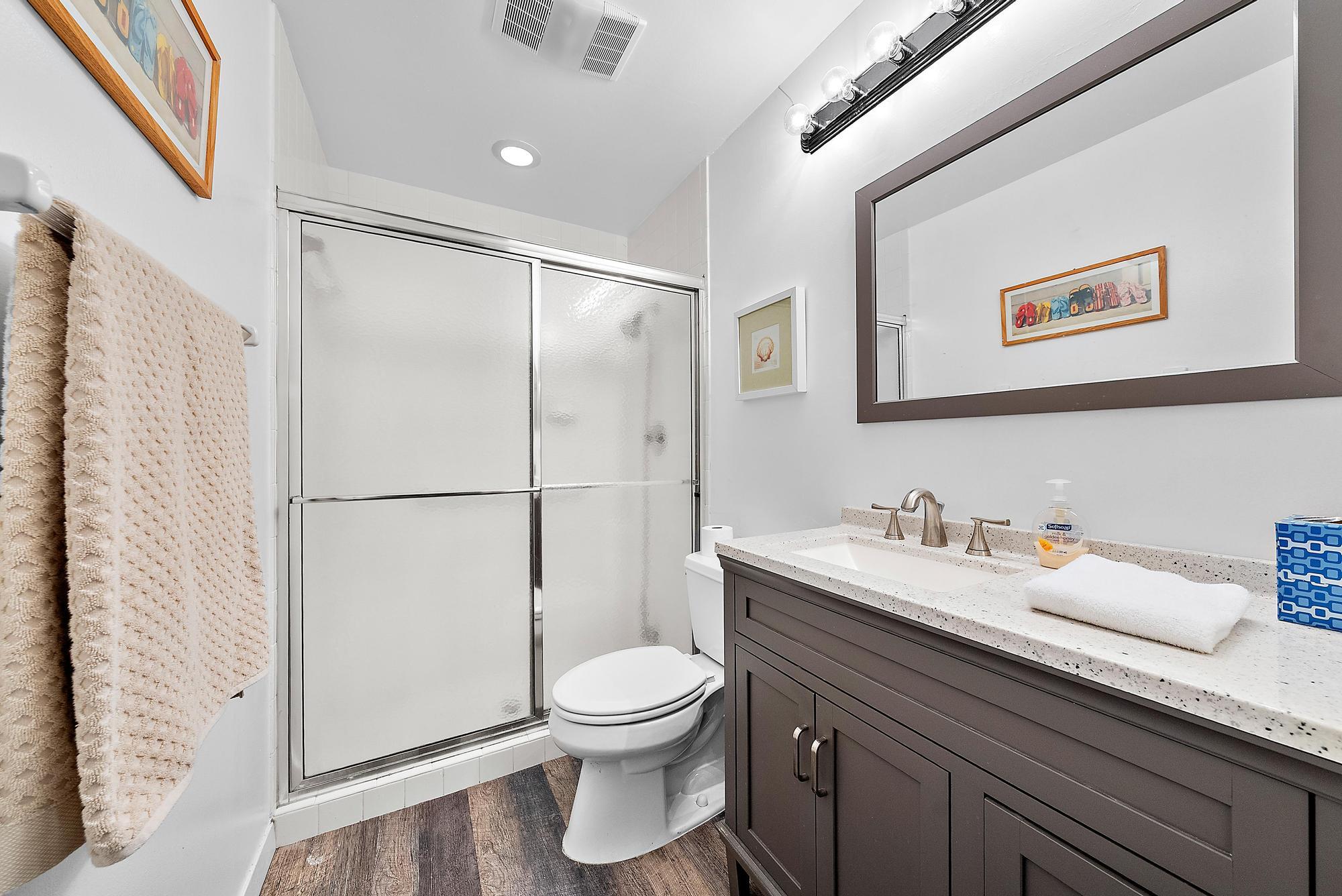 3733 Cape Pointe Circle Jupiter, FL 33477 - Photo 18 of 38 a bathroom with a toilet sink and mirror